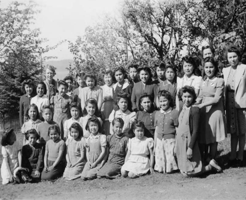 Group of girls kneeling and standing outside from Port Simpson Crosby Home for Girls