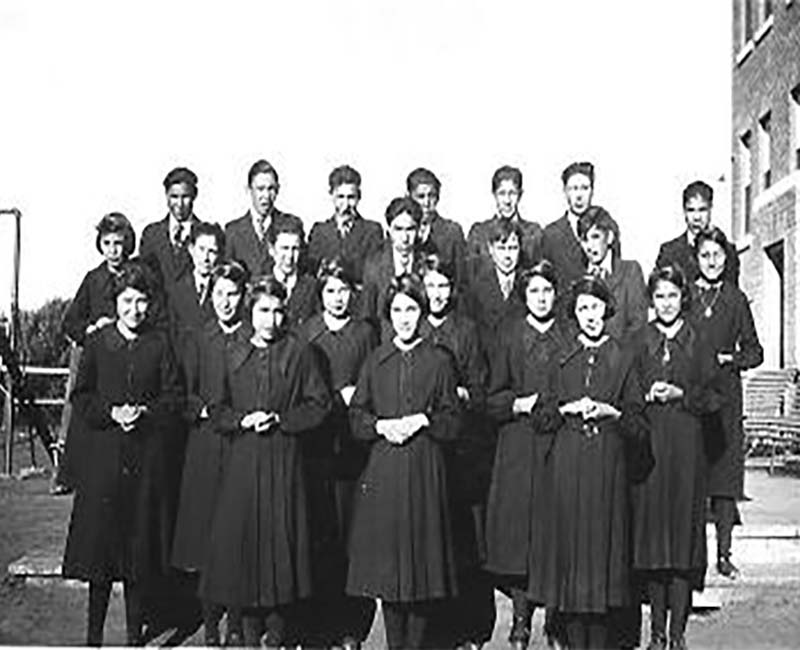 group of people outside St. Michaels Duck Lake school 