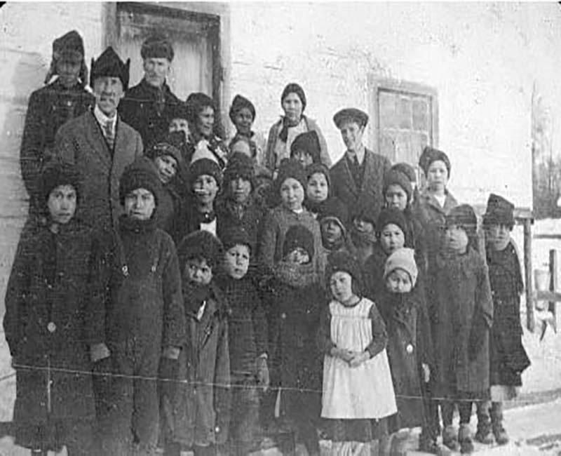 Group of students and teachers outside of building at Whitefish Lake St. Andrews school