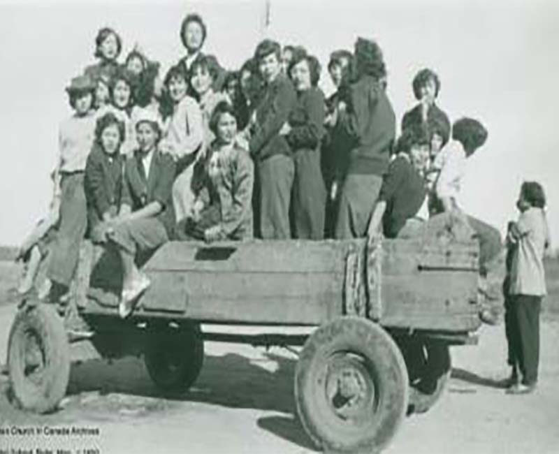 Group of people sitting and standing in trailer