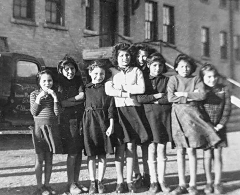 Group of students posing outside for photo in front of Elkhorn school