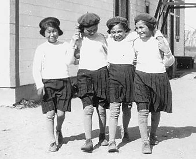 Four students walking outside at Fort George Church of England school