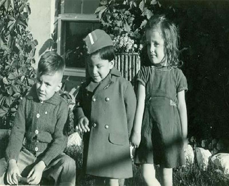 Three students outside posing for picture from McIntosh school