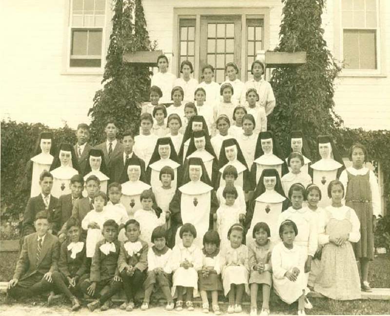 Group of people outside of building at McIntosh school