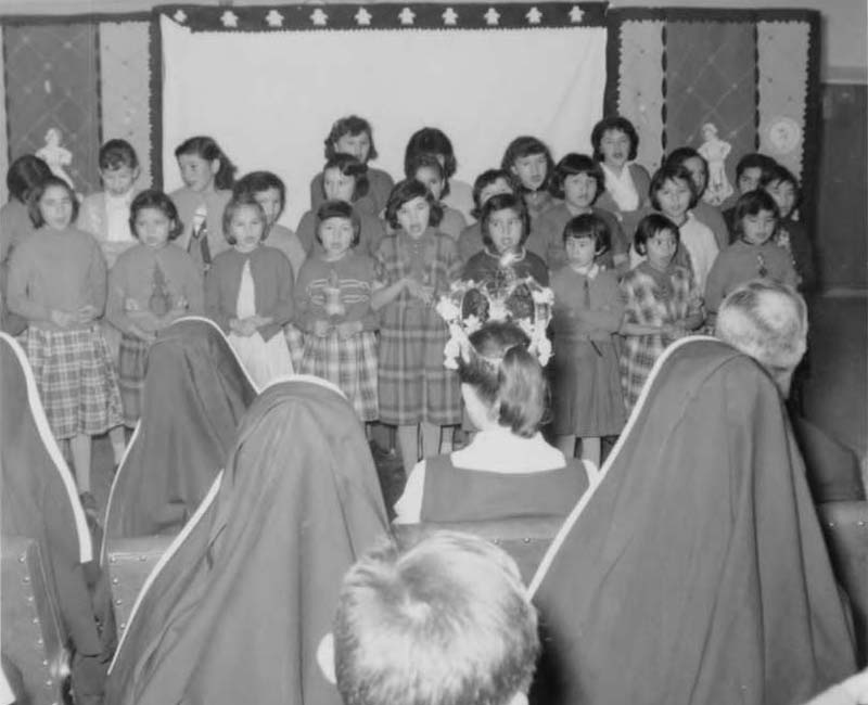 Group of children singing on stage from Pointe Bleue school