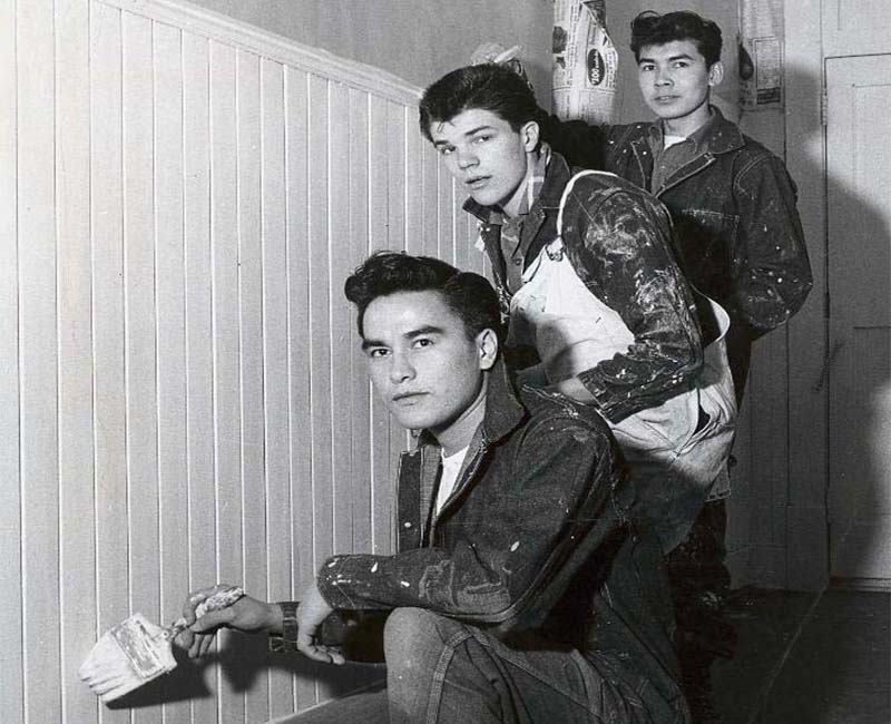 Group of three people painting wall