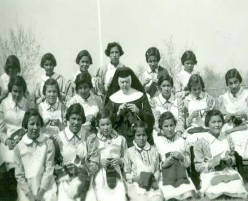 Group of students and teacher posed for photo outside St. Phillips school