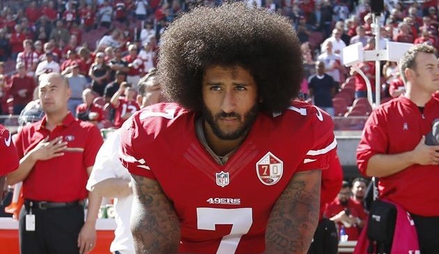 NFL player Colin Kaepernick in 2016, kneeling to protest racial injustice in the U.S.