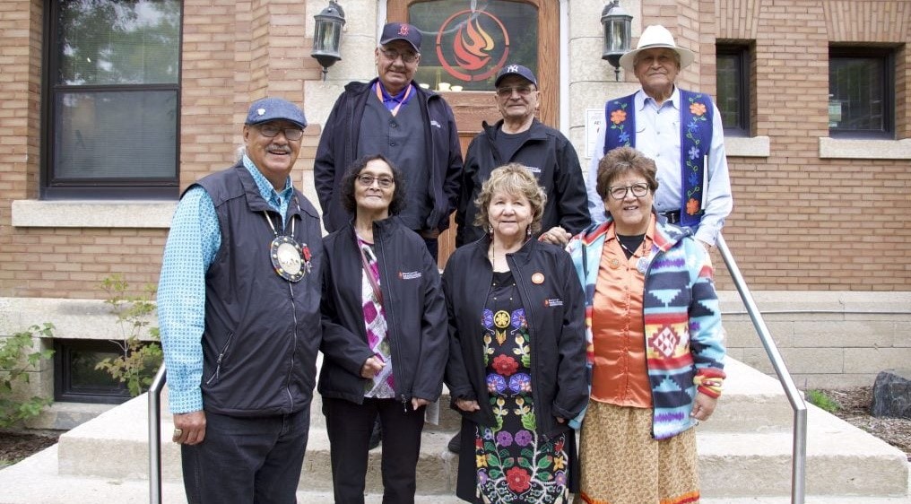 Photo of Eugene and Lorna Arcand standing with members of the Survivors Circle in front of the National Centre for Truth and Reconciliation.
